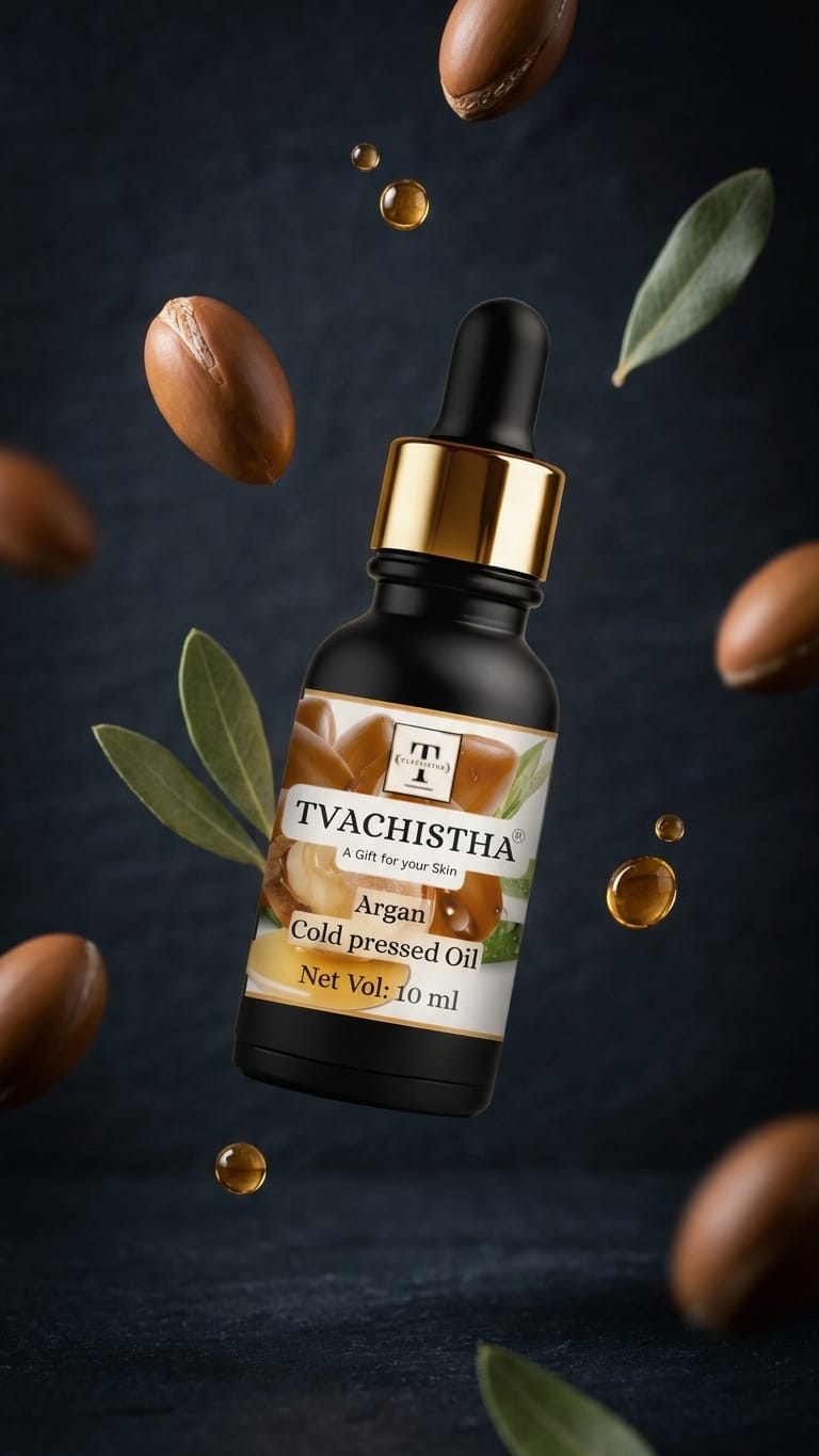 A black glass dropper bottle of Tvachistha Cold Pressed Argan Oil showing its rich, unrefined golden texture.