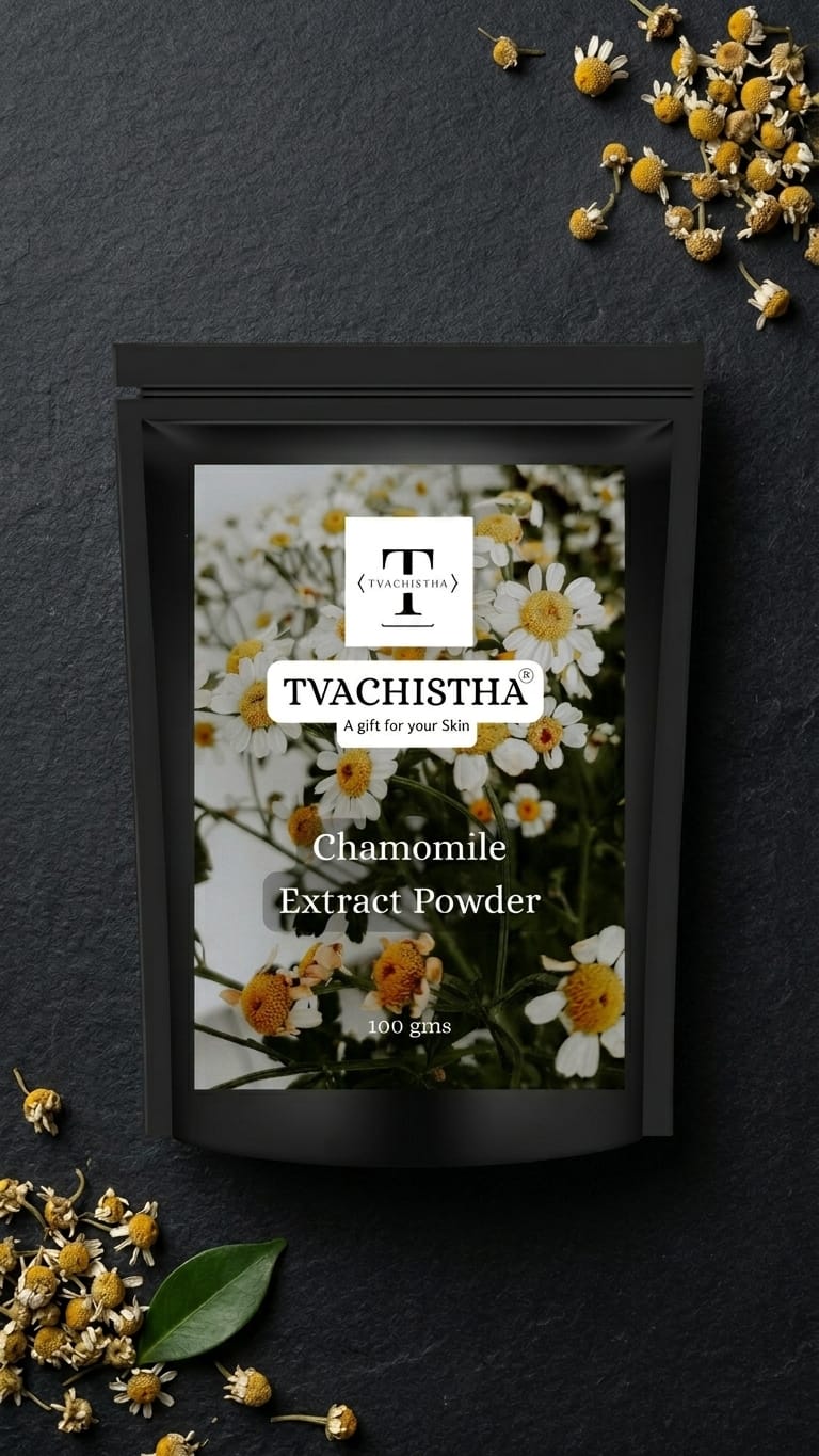A stand-up pouch of Tvachistha Chamomile Extract Powder, featuring a white and black label with chamomile flowers, set against a dark slate background decorated with loose chamomile flowers and green leaves.